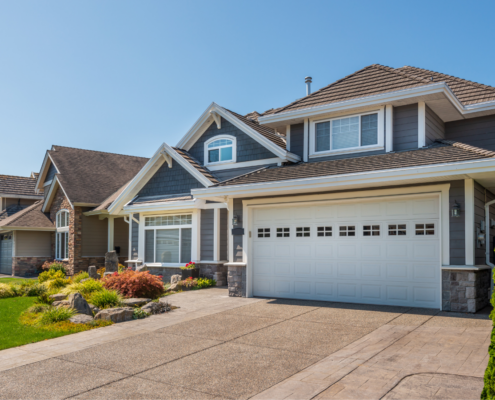 Newly built suburban home with modern exterior, driveway, and landscaped front yard