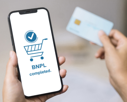 Consumer reviewing Buy Now, Pay Later payment options on a smartphone while managing personal finances.